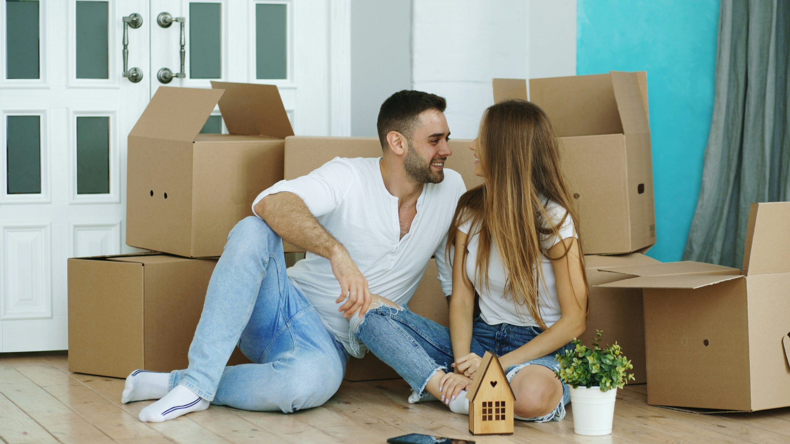 Happy couple in front of their new home