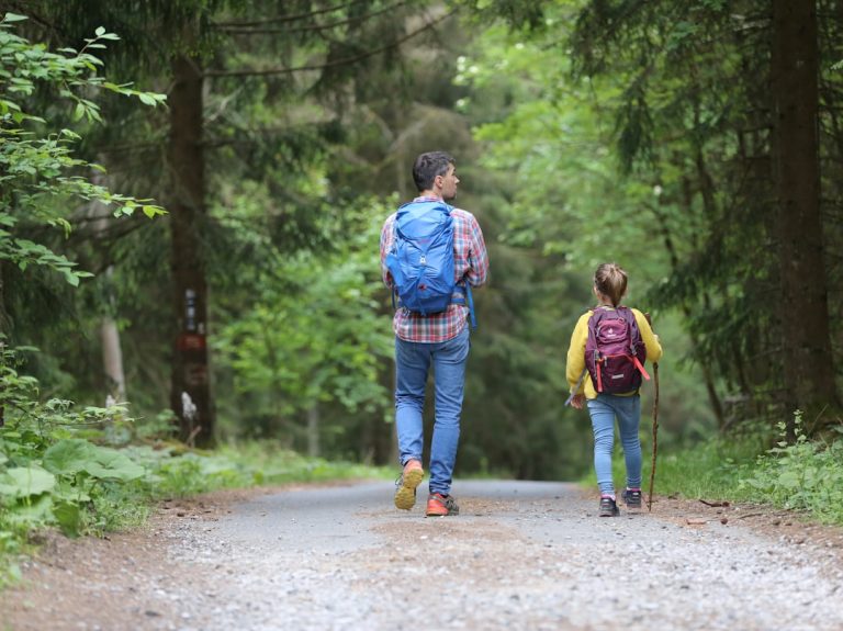 Father and daughter walking a family-friendly hiking trail near Seattle