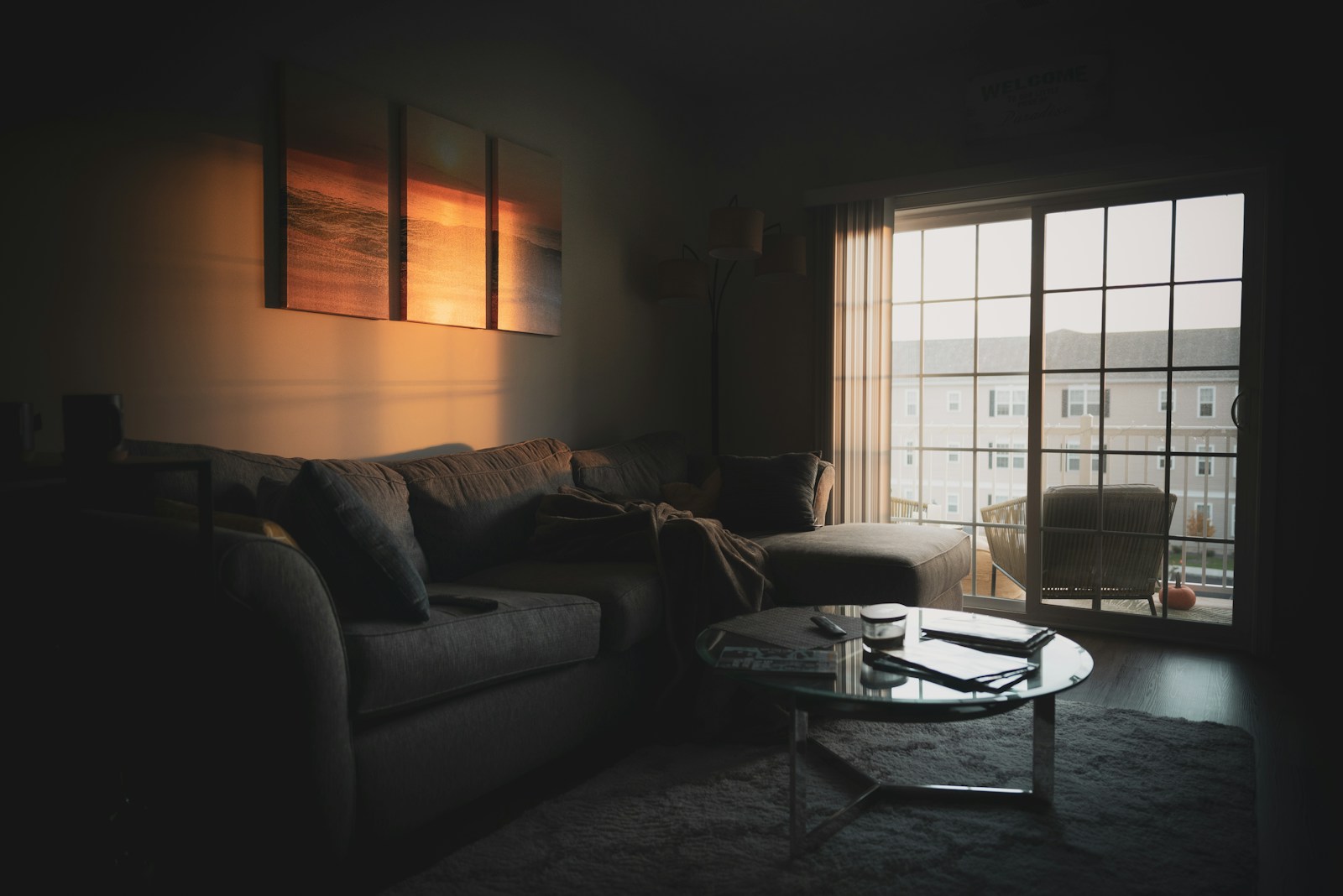 New townhome living room with large windows lit up at night in Seattle