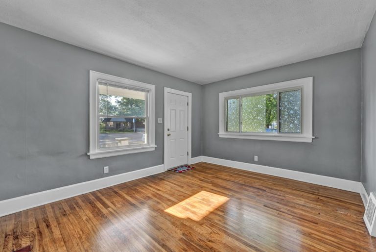 Empty move-in-ready bedroom with refinished hardwood floors in an inherited home ready to list