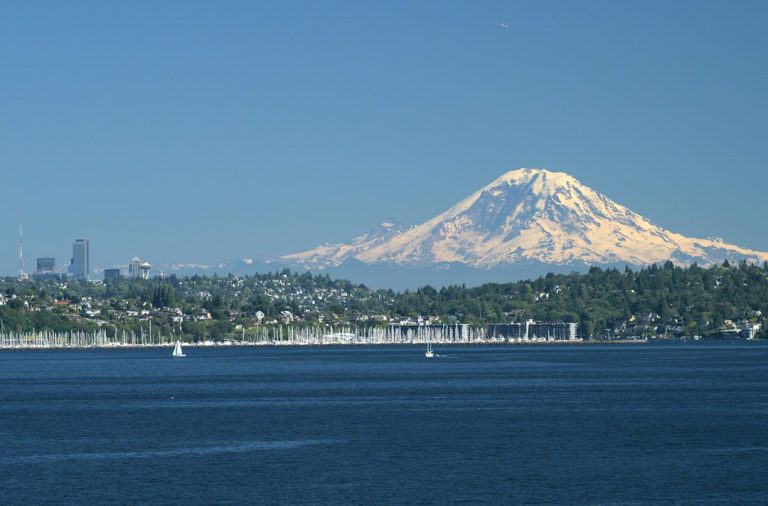Seattle skyline and Mt. Rainier view from a Puget Sound bluff neighborhood like Magnolia