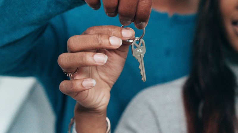Couple holding a house key after buying a home
