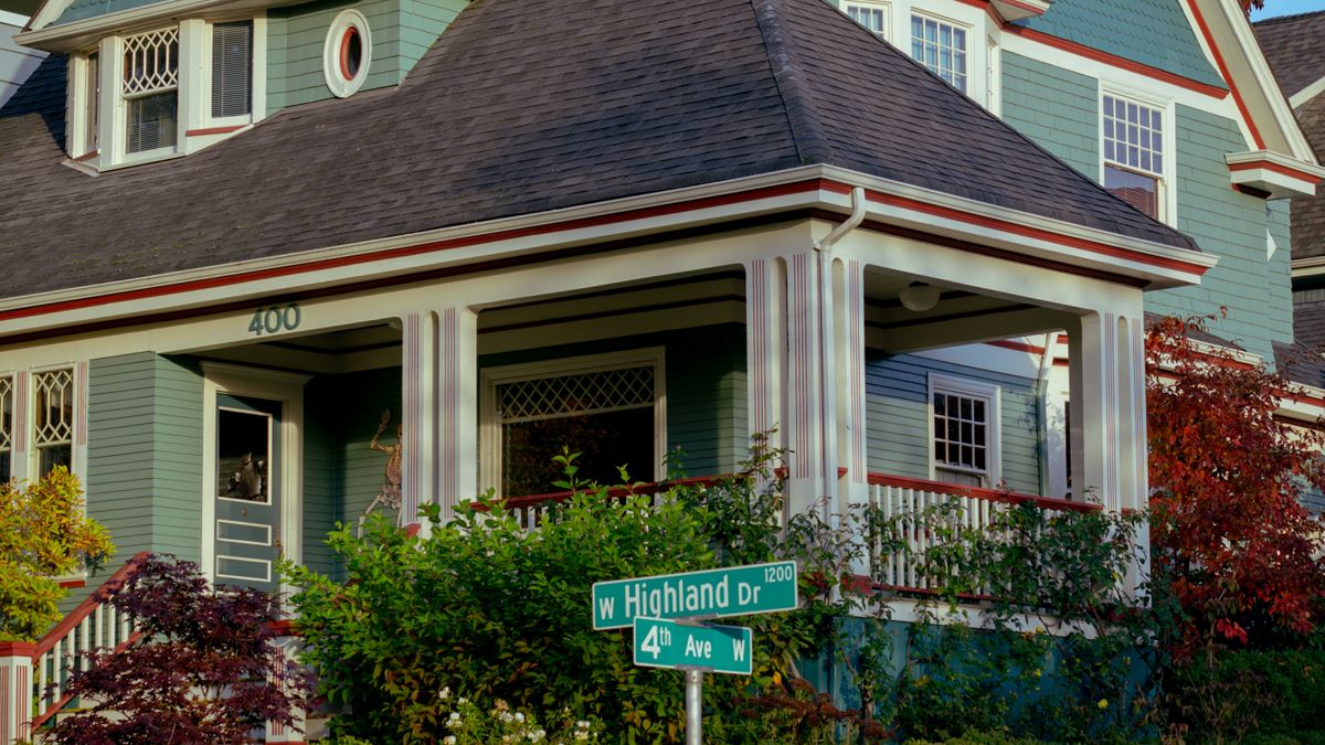 Craftsman-style house with a large front porch on a tree-lined street