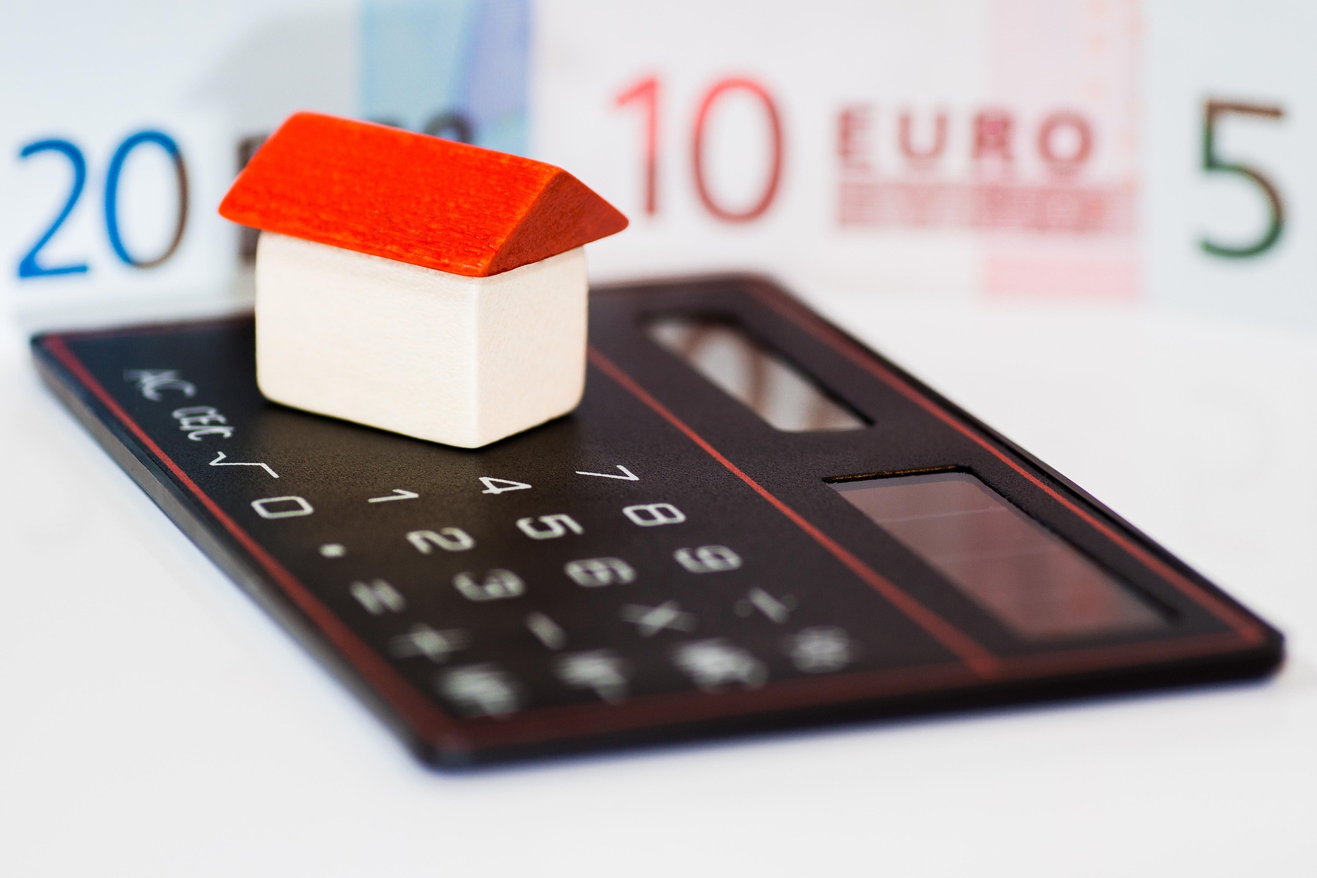 Calculator and financial documents representing mortgage rate calculations for Seattle home buyers