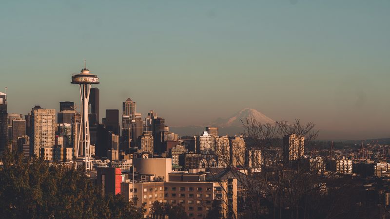 Seattle skyline with the Space Needle and Mount Rainier, where King County home sales slowed sharply in July